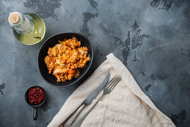 One pot chicken enchilada, rice casserole, on gray background,\
top view flat lay with copy space for text