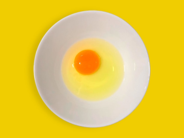 One raw egg white and yolk inside bowl