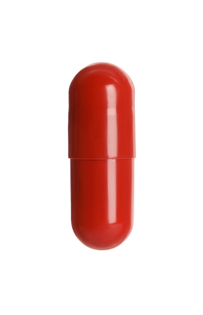 One red pill on white background Medicinal treatment