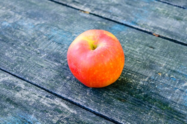 One ripe apples on rustic wooden table