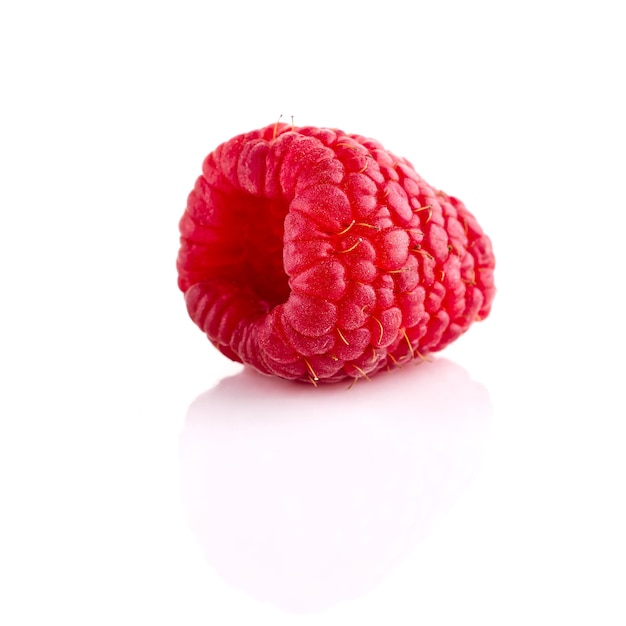 One ripe raspberry isolated on white backdrop