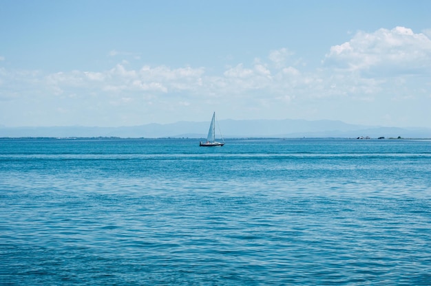 One sailboat is sailing in the sea