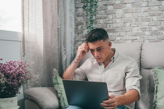 One serious and focused young entrepreneur working hard and analyzing market at home Teenager boy studying and doing homework for school alonexA