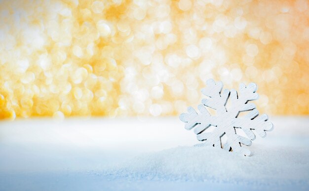 One snowflake in the snow with defocus lights