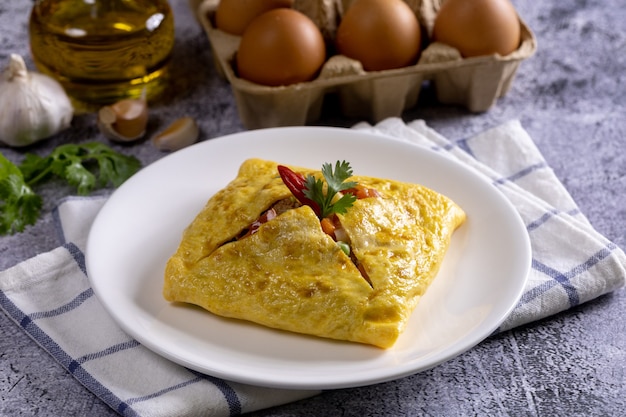 One Stuffed Thai Omelette on white plate