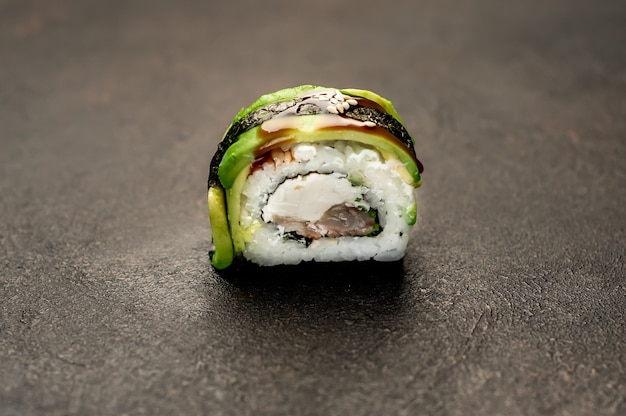 one sushi roll on a stone background