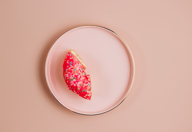 one-third donut symbolizing eight hours on pink background