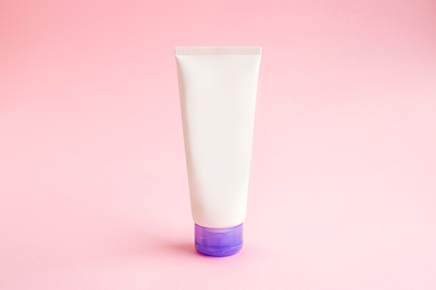 One tube of cream on pink background mockup. beauty spa medical skincare and cosmetic lotion cream packaging product