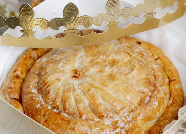 one whole fresh royal galette with a crown in a box