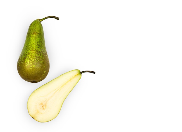 One whole and one split pear are isolated on a white wall Top view