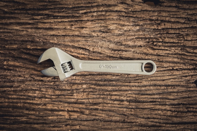 One Wrench on wooden background