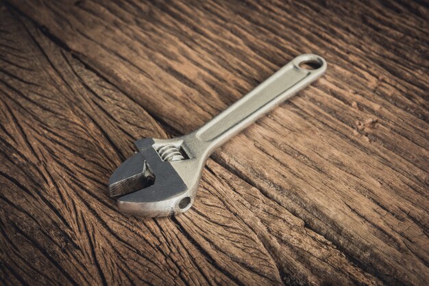 One Wrench on wooden background