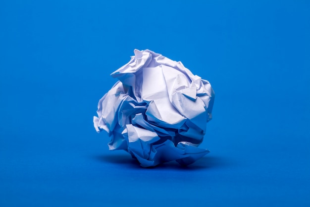 One wrinkled white piece of paper over a blue background.