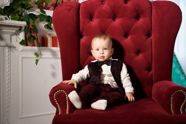 One-year-old cheerful baby boy plays at home. Portrait of a cute playful baby.