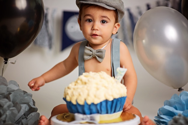 One-year-old cute boy on a gray background