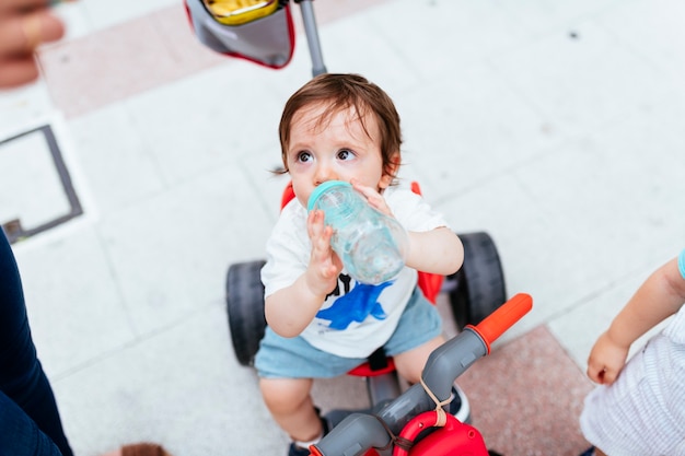 One year old drinking water in the street