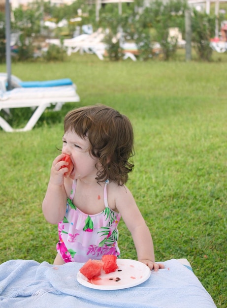 One year old girl eating watermelon