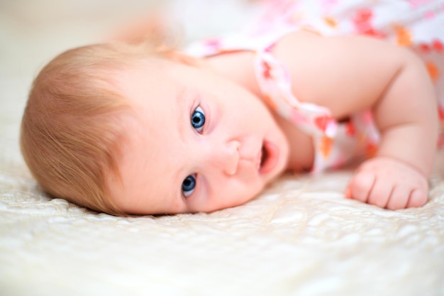 one years old baby girl on a light background