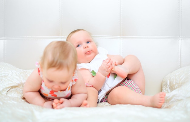 one years old baby girls on a light background