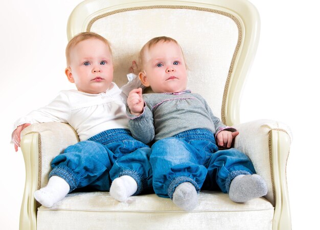 Photo one years old baby girls on a white background