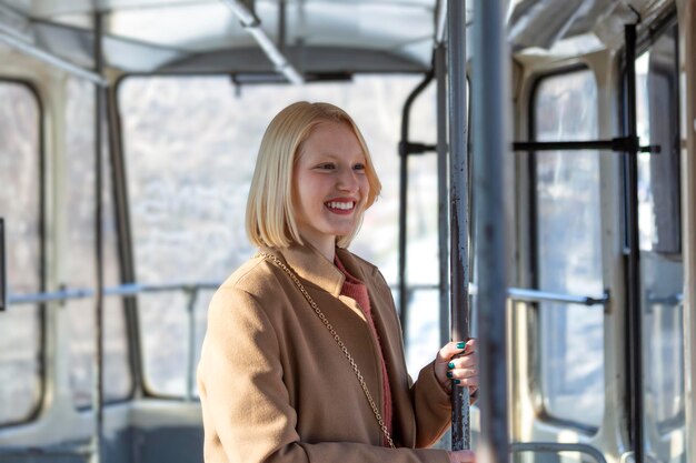 창을 통해 보는 동안 버스에서 웃 고 한 젊은 여자 아름 다운 젊은 여 자가 버스를 복용 합니다. 버스 또는 기차, 기술 라이프 스타일, 교통 및 여행 개념의 승객.