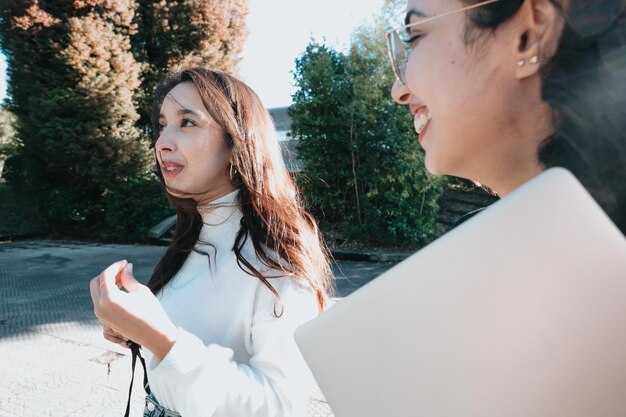 One young woman student explaining something to her friend chit\
chat small talk at university concept funny story and daily\
anecdote of students gossip girls