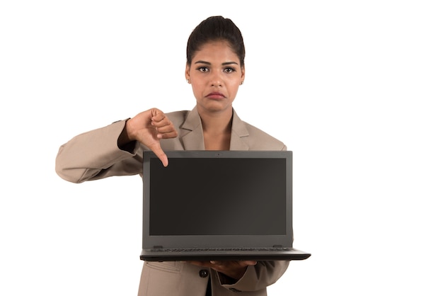 Ongelukkige laptop van de bedrijfsvrouwenholding en het tonen van duimen omlaag geïsoleerd op een witte achtergrond