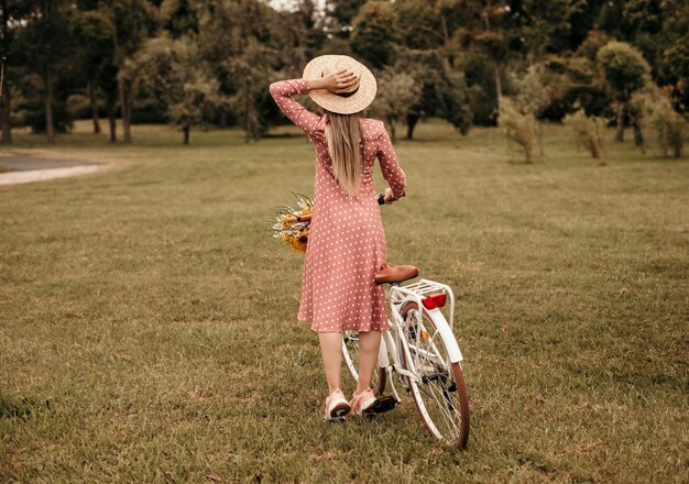 Onherkenbare vrouw met fiets in het veld