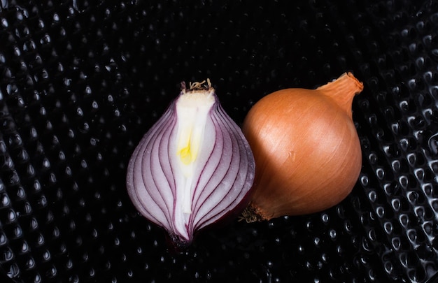 Onion bulb cut in half on background