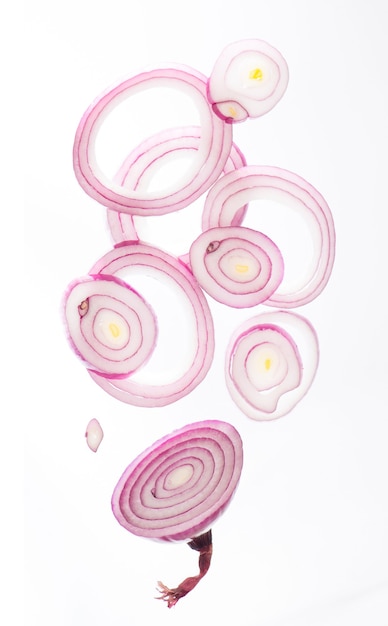 Onion cut into rings drops on white background