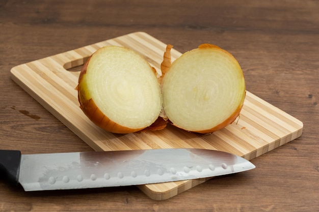 onion cut in two halves on top of cutting board