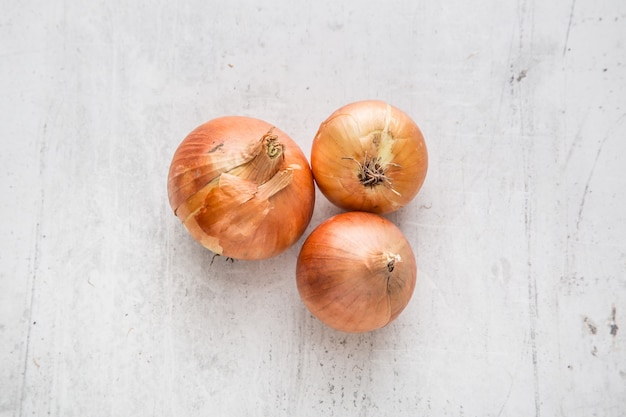 Onion. Fresh onions on white concrete board.