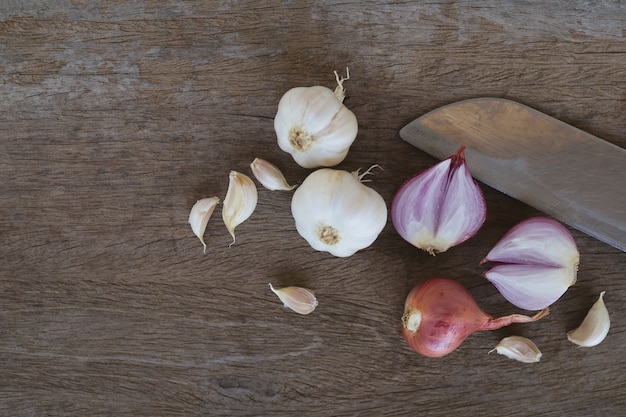 Onion and garlic for cooking on old wooden background