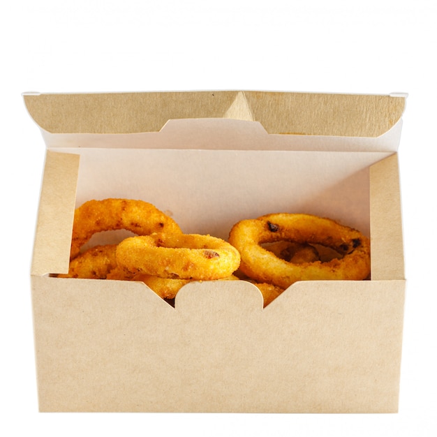 Onion rings fries in paper box to go on white