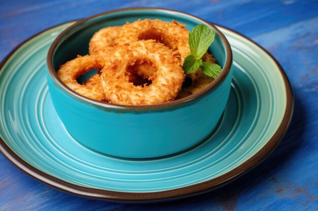 Onion rings placed circularly on a aqua blue dish