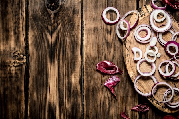 Onion rings with seeds on a wooden Board on wooden table.