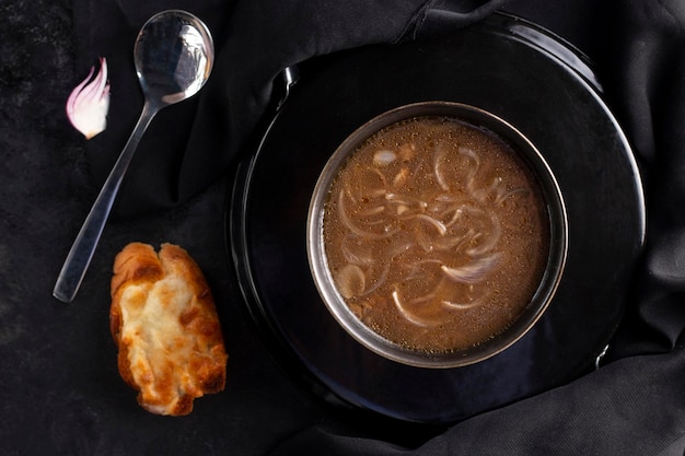 Onion Soup in a black bowl