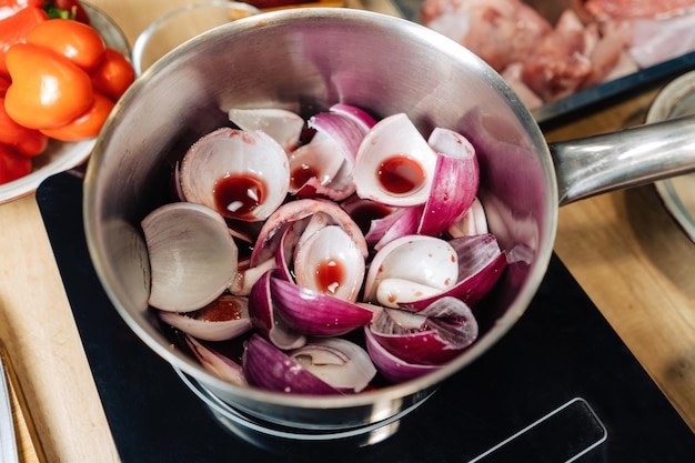 Onions borettane pickles in a saucepan filled with red wine Delicacy a dish from the chef Clouseup