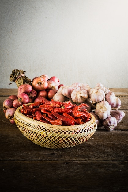 Onions,garlic and dry chili on wooden table