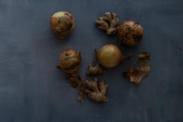 Onions and ginger on a rustic background still life food