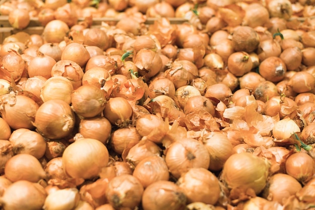 Onions in store in vegetable section of supermarket Closeup selective focus