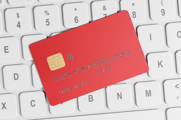 흰색 컴퓨터 키보드 배경에 빨간색 플라스틱 카드가 있는 온라인 뱅킹 개념