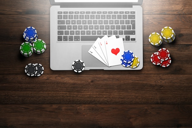 Online casino, laptop, chips cards on wood 