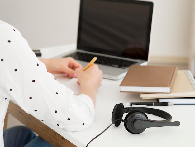 Photo online classes with student and pile of books