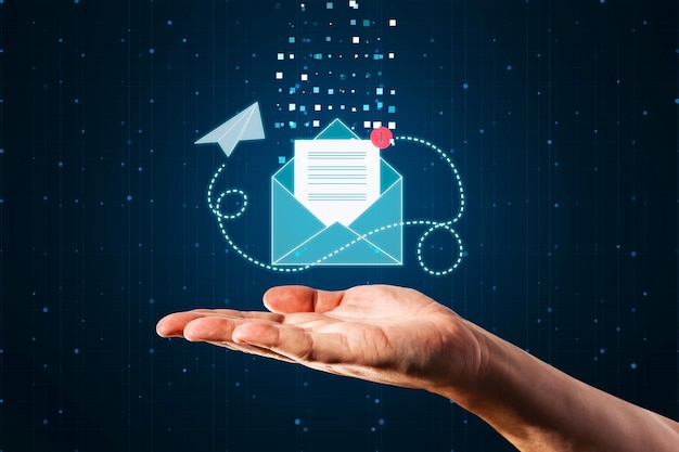 online communication letter email and newsletter concept with paper list in blue envelope with paper airplane flying around above man hand palm on abstract dark background