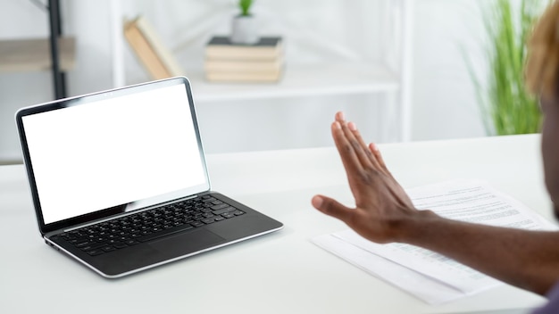 Online conference stop gesture digital mockup unrecognizable black man sitting work desk showing