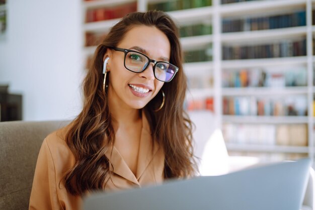 Online conference training Student girl working with laptop learning in college library Freelance