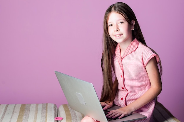 Online courses education small girl pupil with laptop child study online E learning at private lesson home schooling 4G internet girl has private teaching at home back to school copy space