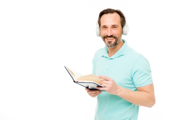 Online education. Man mature bearded guy listening online course. Get more information. Audio book. Reading and listening. Modern education concept. Benefits of online education. Access to knowledge.