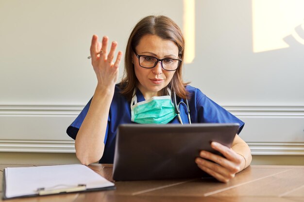 Online general practitioner consultation, female using digital tablet for video call, doctor talking to patient. Telemedicine, healthcare, people concept